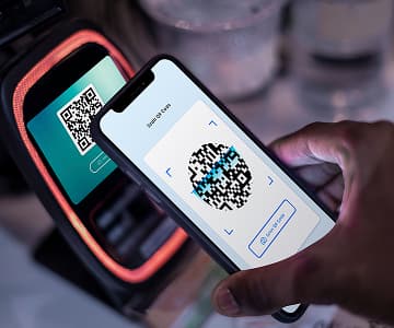 Smartphone scanning a QR code for a contactless payment